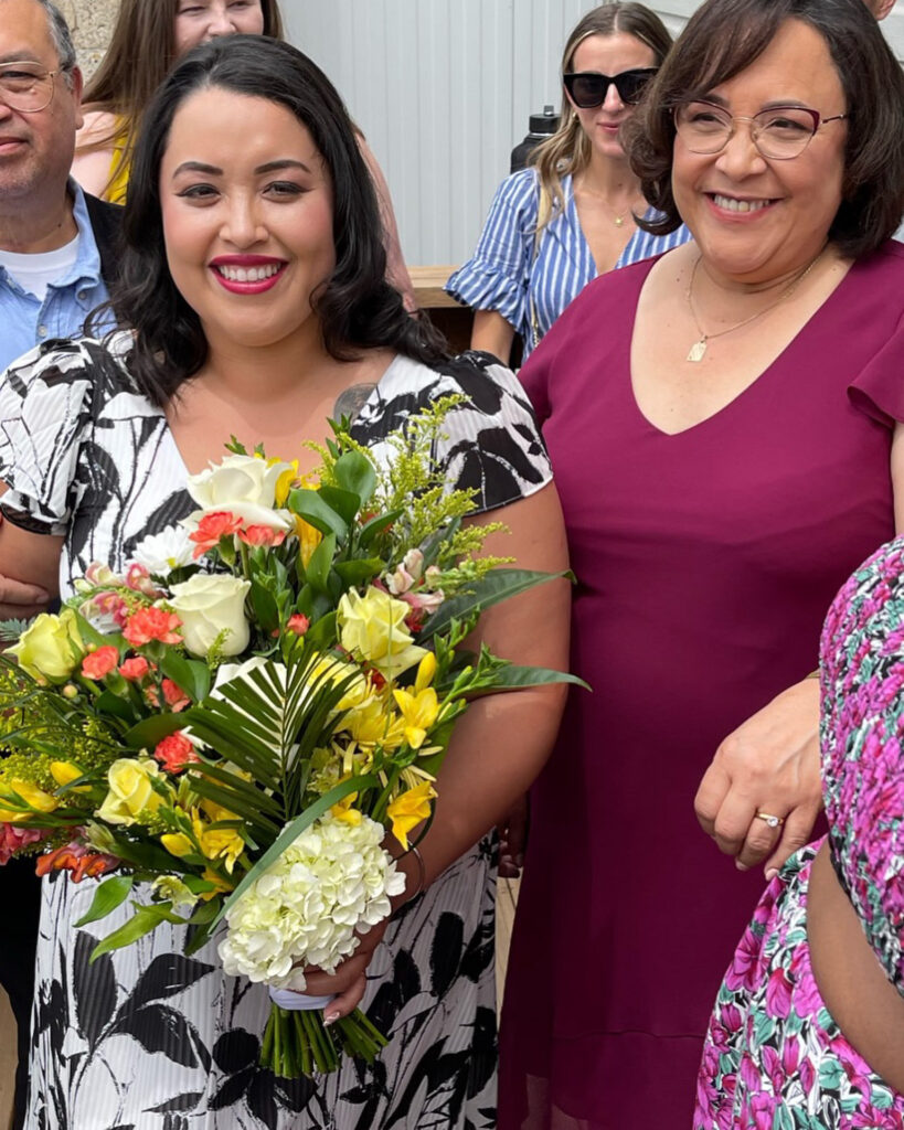 My mother and I were at my wedding. Holding a bouquet. My dad is in the Background.